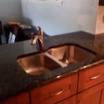 No more backsplash, granite overhangs in back for a couple of barstools.